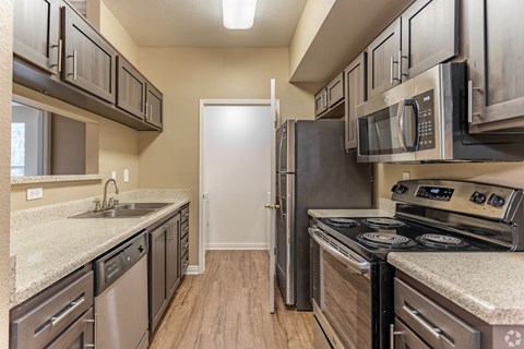 This unit boasts a spacious, freshly renovated kitchen complete with sleek stainless steel appliances.at The Hills at Quail Run in Riverside, California